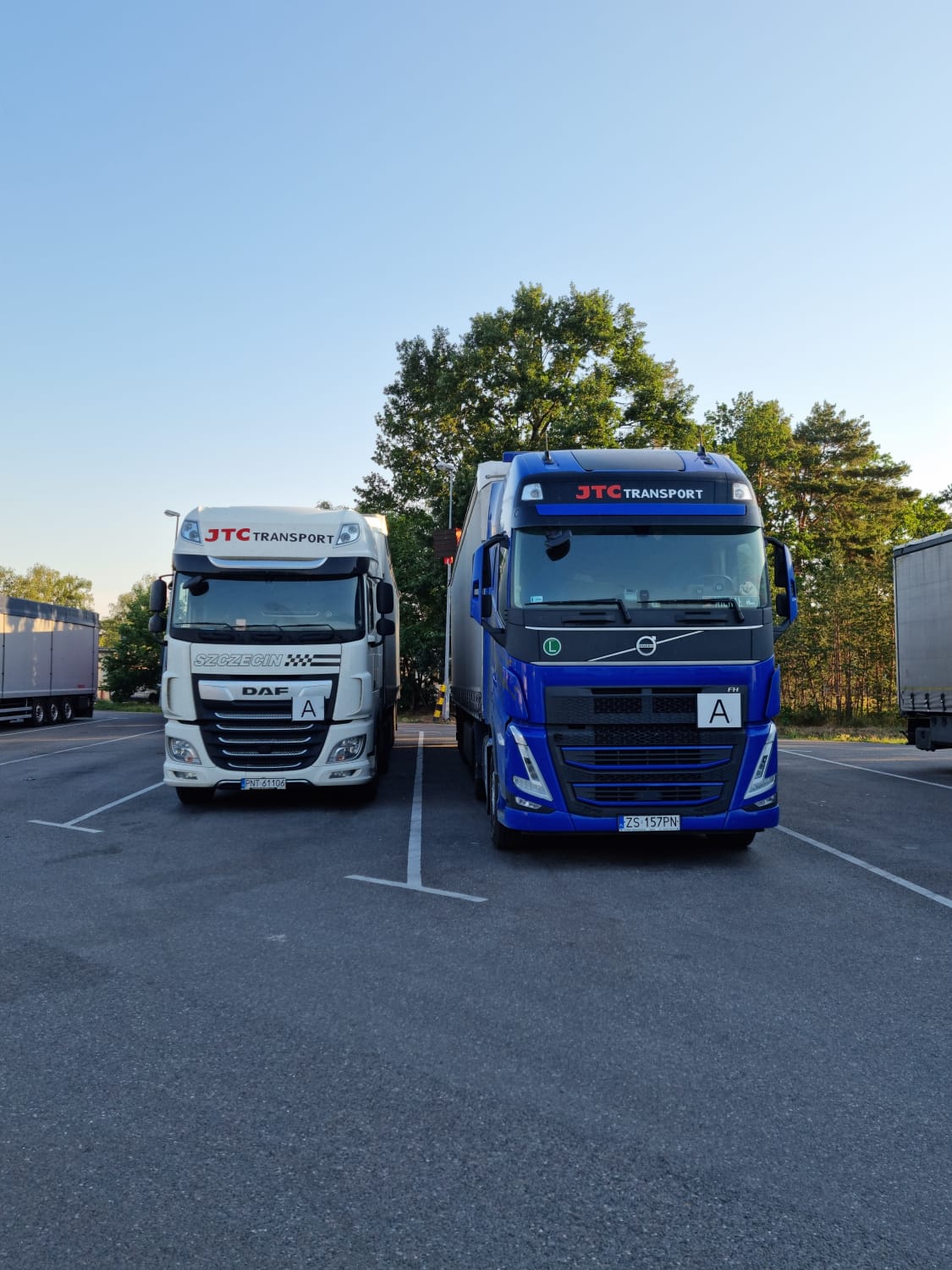 White and blue trucks are parked